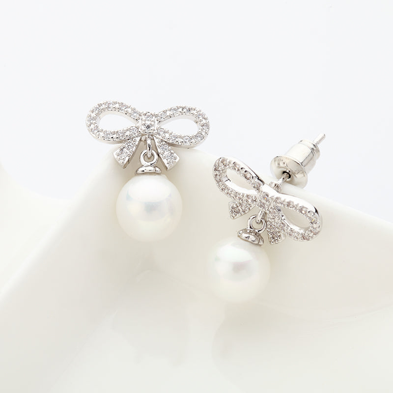 Stunning bridal bow White Sea shell pearl stud earrings.